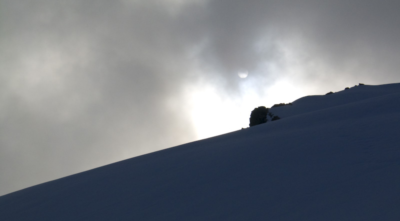 Sun Through Clouds Above Ridgeline